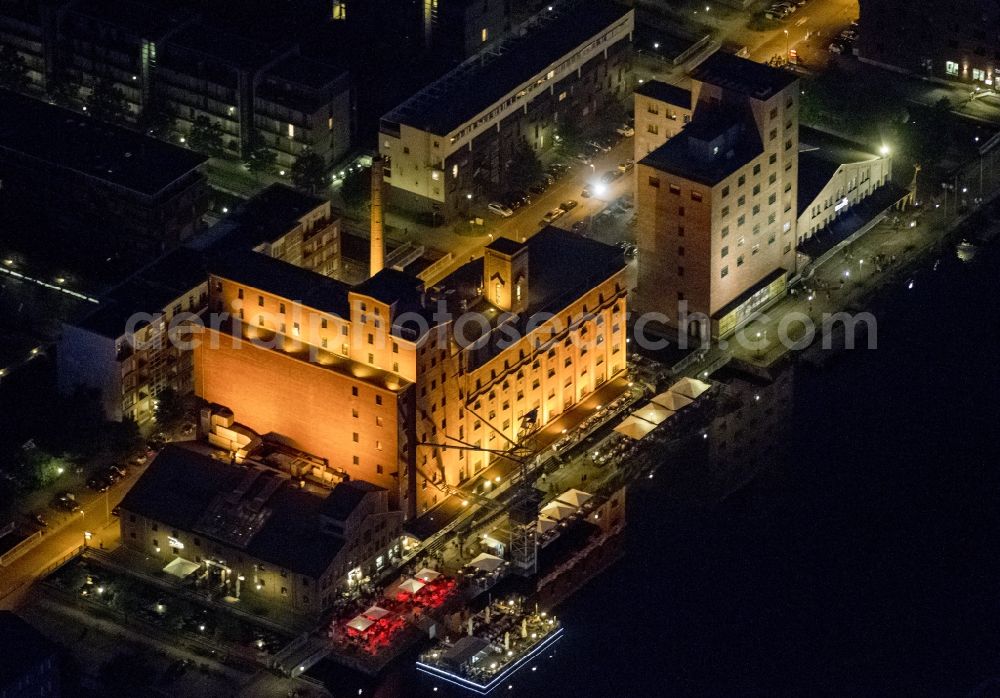 Duisburg at night from the bird perspective: Night Aerial view of the inner harbor of Duisburg on the Philosophers'. The new use of the former river port consists of a mixture of commercial, event and office properties