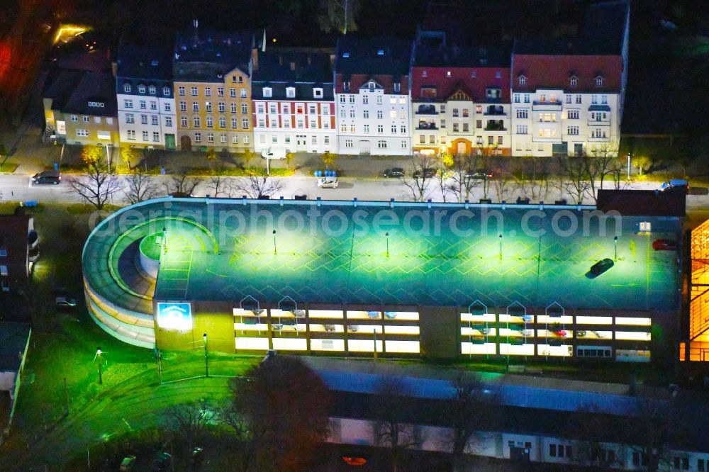 Aerial image at night Strausberg - Night lighting Parking deck on the building of the car park on Hegermuehlenstrasse in Strausberg in the state Brandenburg, Germany