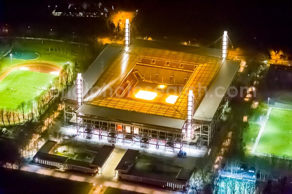 Köln at night from the bird perspective: Night view at the RheinEnergieStadium in the district Müngersdorf in Cologne in the federal state North Rhine-Westphalia. The RheinEnergieStadion is the home ground of the 1. FC Köln. Owner is the Kölner Sportstätten GmbH