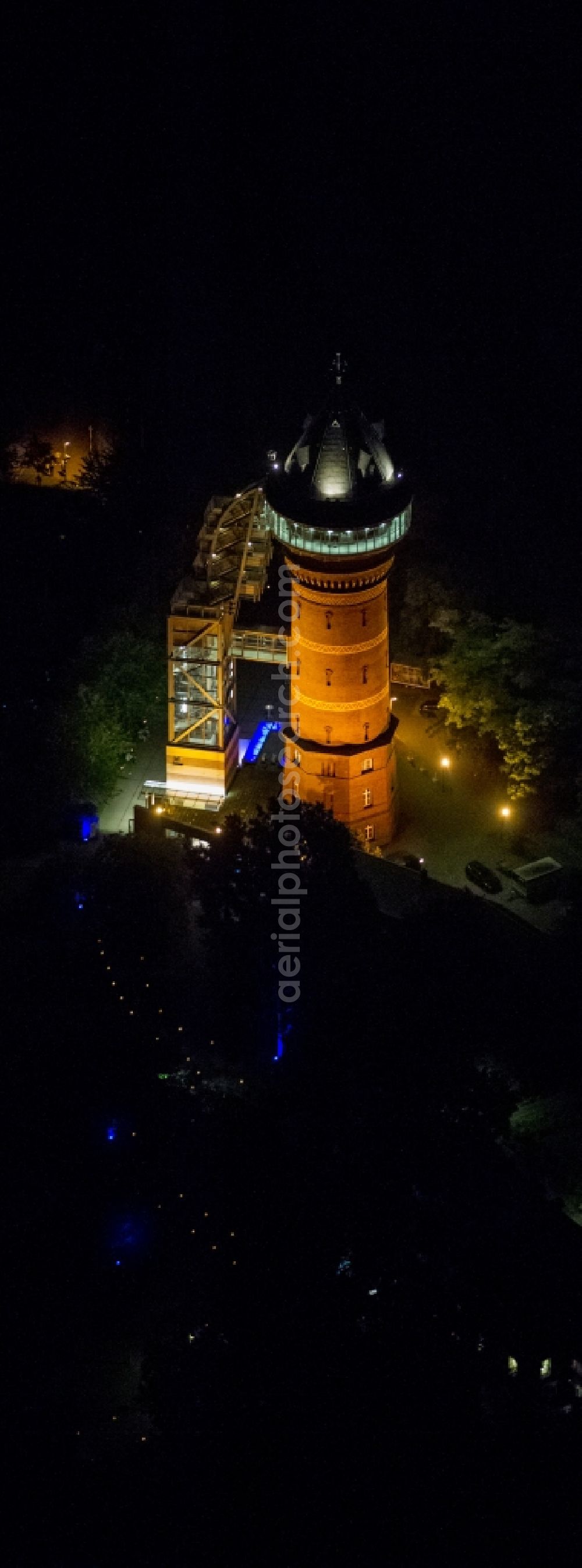 Mülheim at night from the bird perspective: The Aquarius Water Museum in Styrum, a district of Mülheim an der Ruhr, is located in a disused water tower and is part of the Route of Industrial Heritage