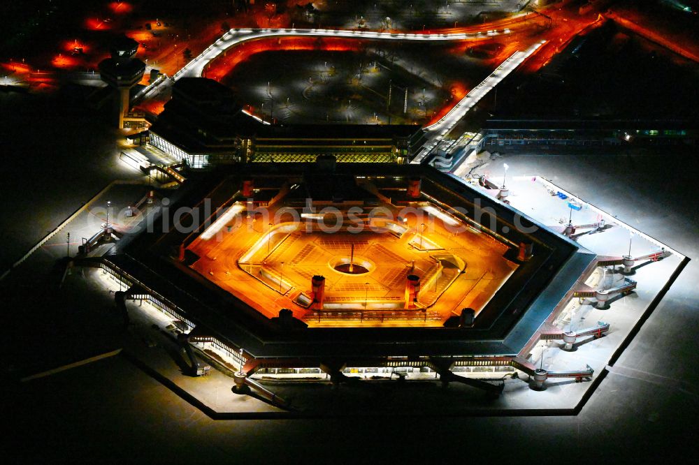 Aerial image at night Berlin - Night lighting dispatch building and terminals on the premises of the former airport in the district Tegel in Berlin, Germany