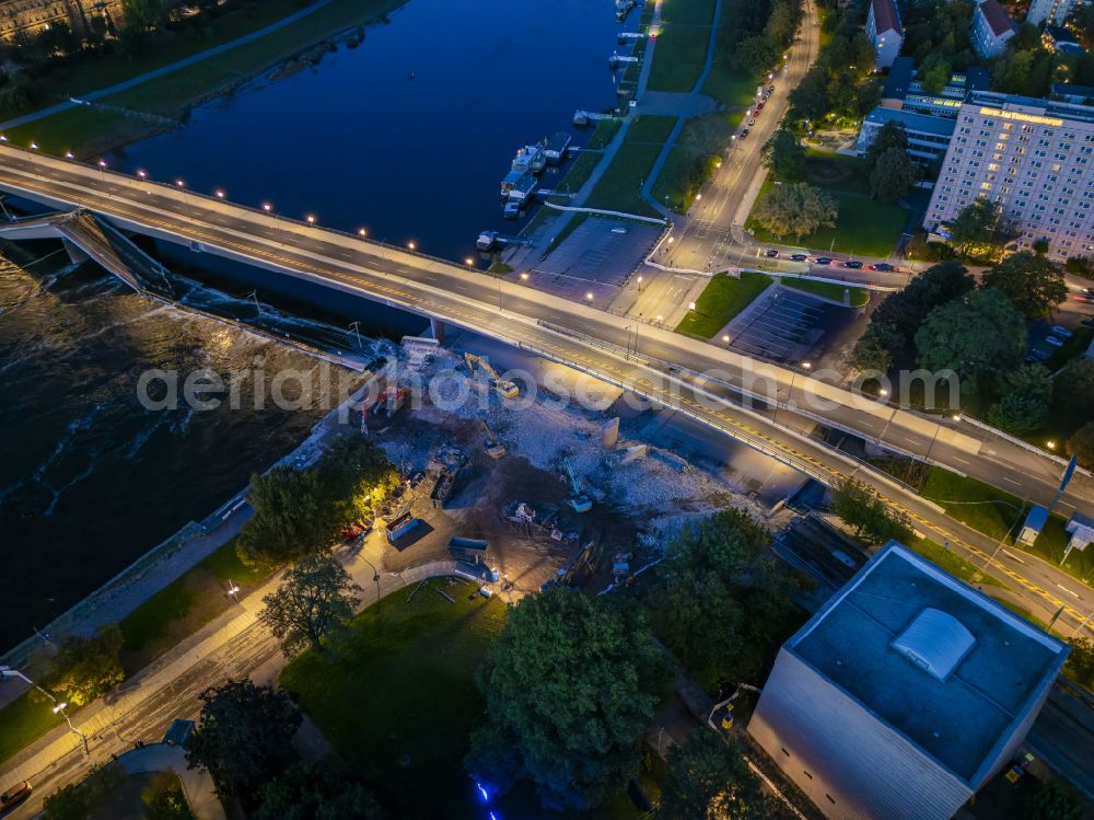 Aerial photograph at night Dresden - Night lighting concrete segments of the collapsed river bridge structure for crossing the Elbe Carolabruecke on the street Carolabruecke in Dresden in the federal state of Saxony, Germany, have fallen down into the riverbed of the Elbe