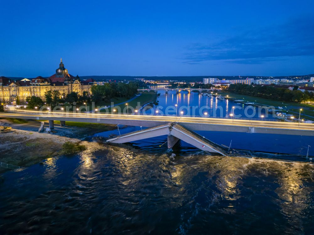 Aerial photograph at night Dresden - Night lighting concrete segments of the collapsed river bridge structure for crossing the Elbe Carolabruecke on the street Carolabruecke in Dresden in the federal state of Saxony, Germany, have fallen down into the riverbed of the Elbe