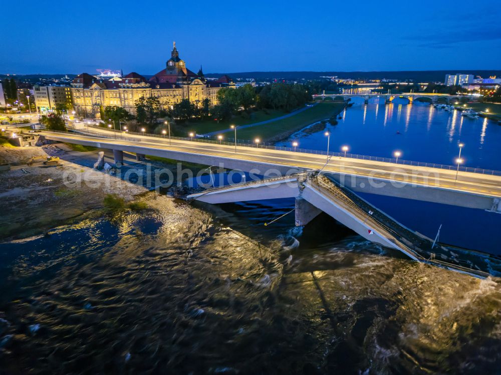 Aerial image at night Dresden - Night lighting concrete segments of the collapsed river bridge structure for crossing the Elbe Carolabruecke on the street Carolabruecke in Dresden in the federal state of Saxony, Germany, have fallen down into the riverbed of the Elbe