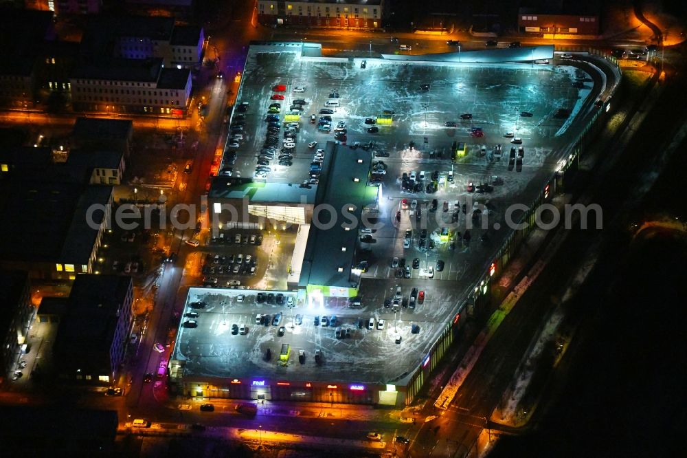 Lübeck at night from the bird perspective: Night lighting building of the shopping center Campus Luebeck on Alexander-Fleming-Strasse in the district Strecknitz in Luebeck in the state Schleswig-Holstein, Germany