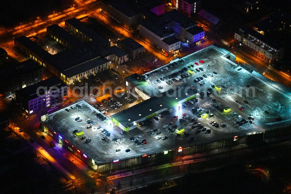 Aerial photograph at night Lübeck - Night lighting building of the shopping center Campus Luebeck on Alexander-Fleming-Strasse in the district Strecknitz in Luebeck in the state Schleswig-Holstein, Germany