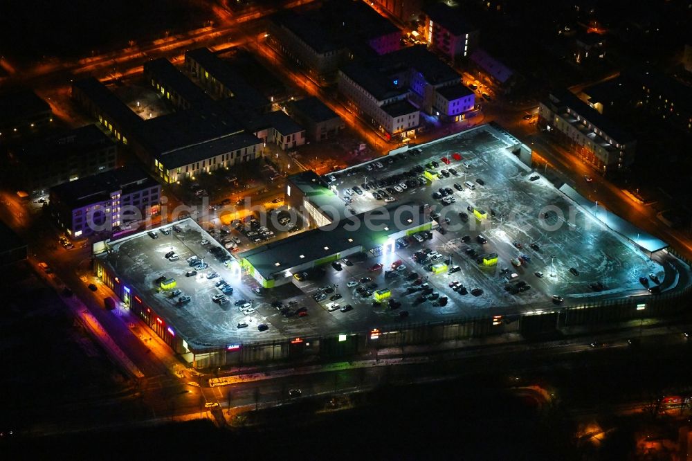 Aerial image at night Lübeck - Night lighting building of the shopping center Campus Luebeck on Alexander-Fleming-Strasse in the district Strecknitz in Luebeck in the state Schleswig-Holstein, Germany