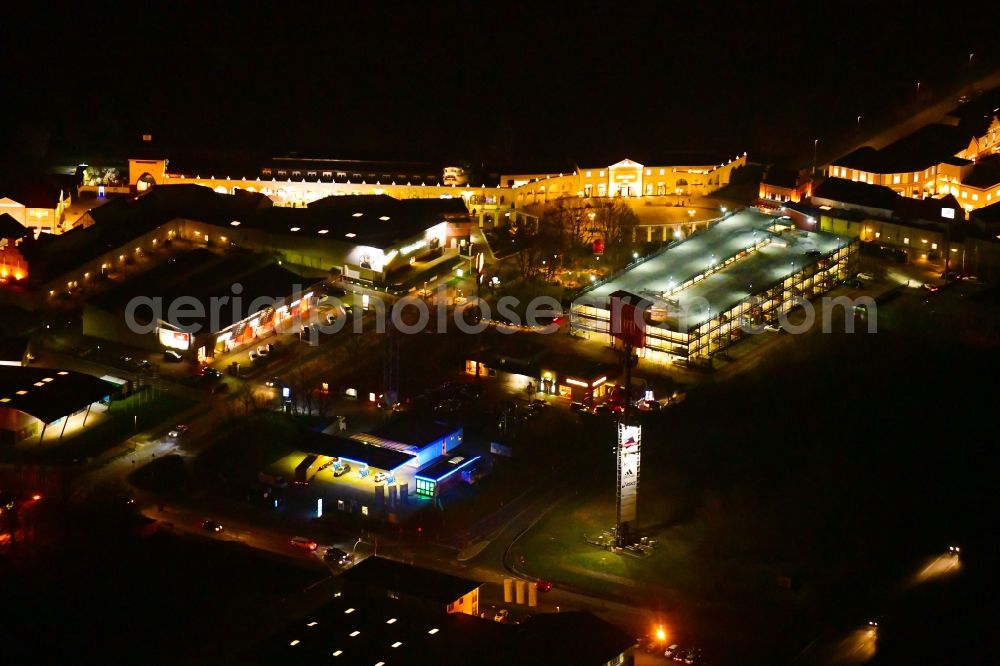 Wustermark at night from above - Night lighting building of the shopping center Designer Outlet Berlin in Wustermark in the state Brandenburg, Germany