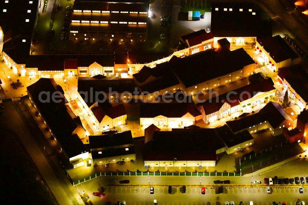 Wustermark at night from above - Night lighting building of the shopping center Designer Outlet Berlin in Wustermark in the state Brandenburg, Germany