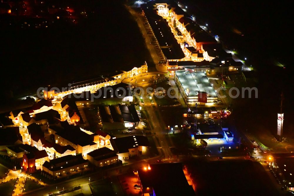 Aerial image at night Wustermark - Night lighting building of the shopping center Designer Outlet Berlin in Wustermark in the state Brandenburg, Germany