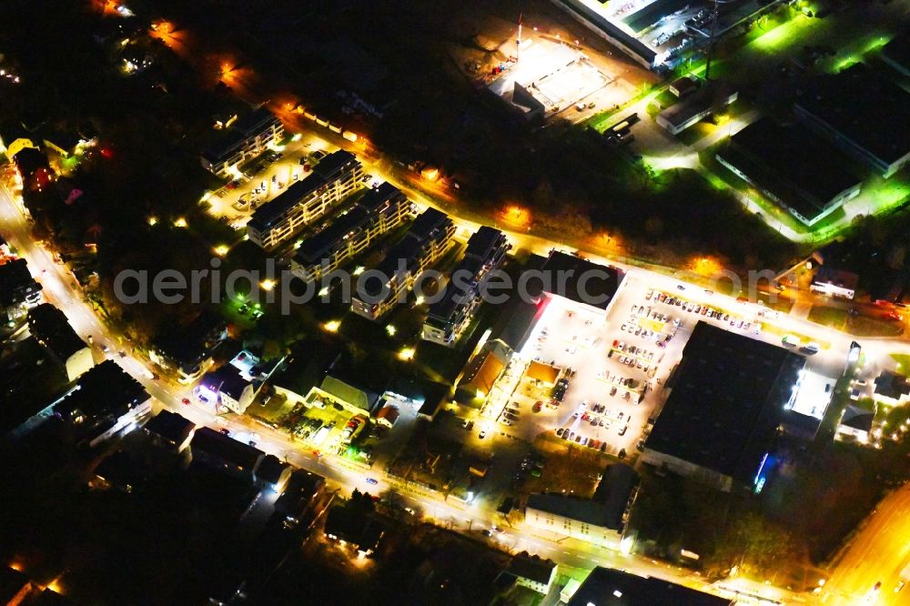 Aerial image at night Berlin - Night lighting Building of the shopping center EDEKA Center Brehm and dm-drogerie markt in Berlin, Germany