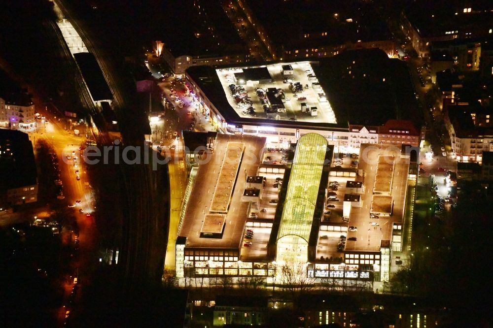 Aerial image at night Berlin - Night lighting building of the shopping center Forum Koepenick in the district Koepenick in Berlin, Germany