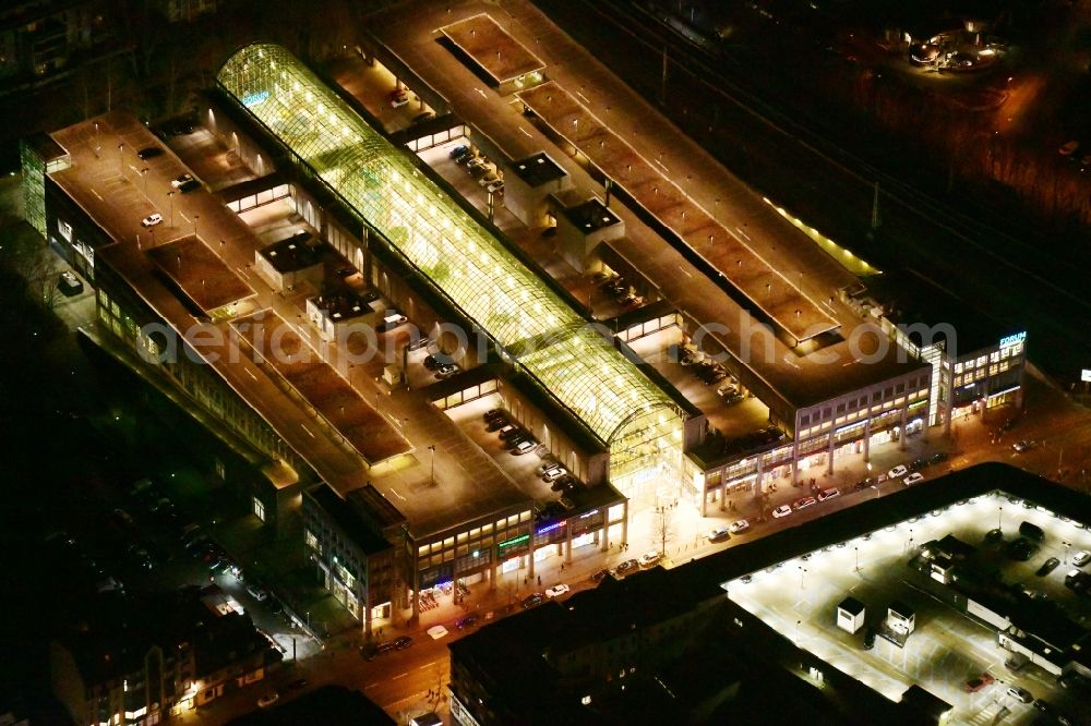 Aerial image at night Berlin - Night lighting building of the shopping center Forum Koepenick in the district Koepenick in Berlin, Germany