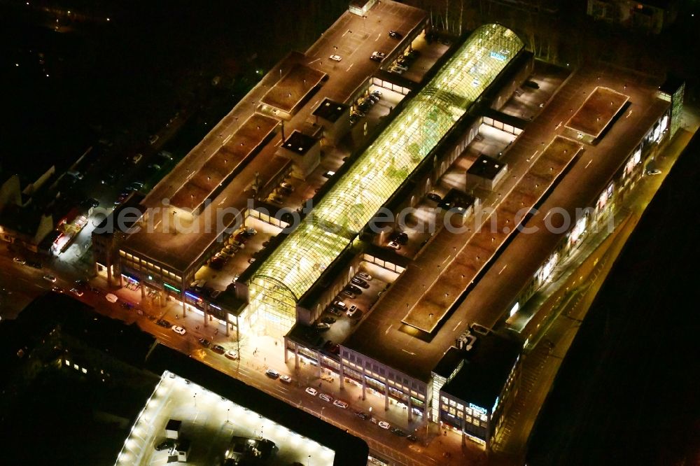 Aerial image at night Berlin - Night lighting building of the shopping center Forum Koepenick in the district Koepenick in Berlin, Germany