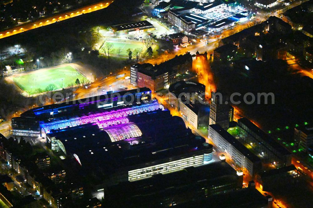 Aerial image at night Berlin - Night lighting Building of the shopping center Hallen on Borsigturm on street Am Borsigturm in the district Tegel in Berlin, Germany