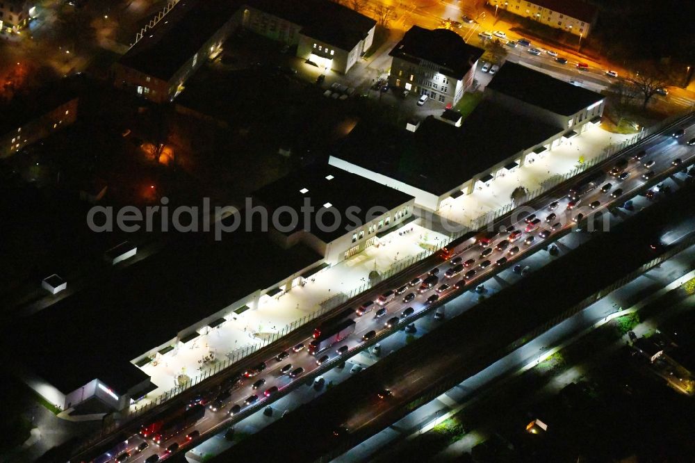 Aerial image at night Ludwigsfelde - Night lighting Building of the shopping center Ludwig Arkaden of McCafferty Asset Management GmbH in Ludwigsfelde in the state Brandenburg, Germany