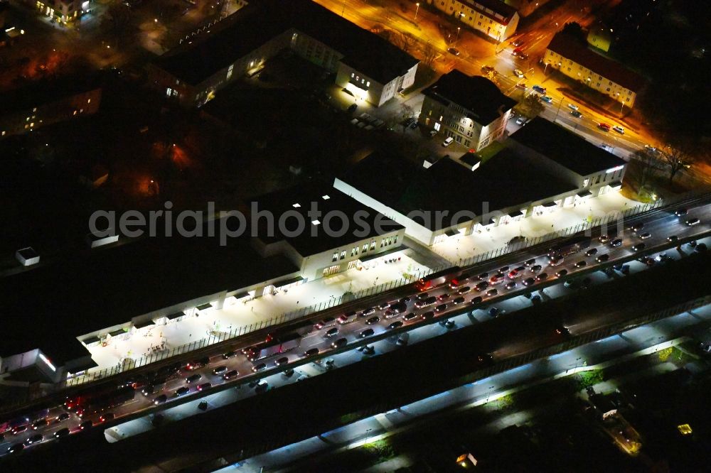 Ludwigsfelde at night from the bird perspective: Night lighting Building of the shopping center Ludwig Arkaden of McCafferty Asset Management GmbH in Ludwigsfelde in the state Brandenburg, Germany