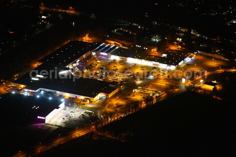 Oranienburg at night from above - Night lighting Building of the shopping center on Friedensstrasse in Oranienburg in the state Brandenburg, Germany