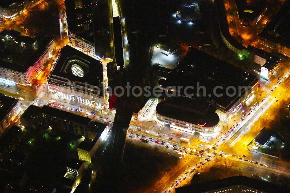 Aerial photograph at night Berlin - Night lighting Building of the shopping center Ring-Center Berlin on Frankfurter Allee in the district Friedrichshain in Berlin, Germany