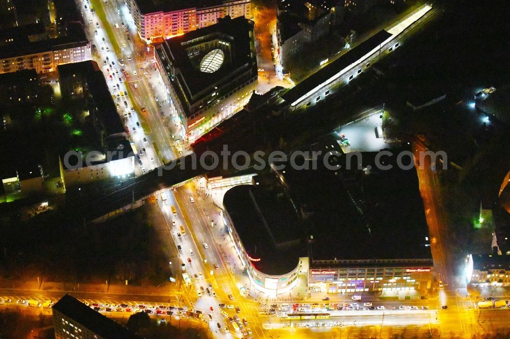 Aerial photograph at night Berlin - Night lighting Building of the shopping center Ring-Center Berlin on Frankfurter Allee in the district Friedrichshain in Berlin, Germany