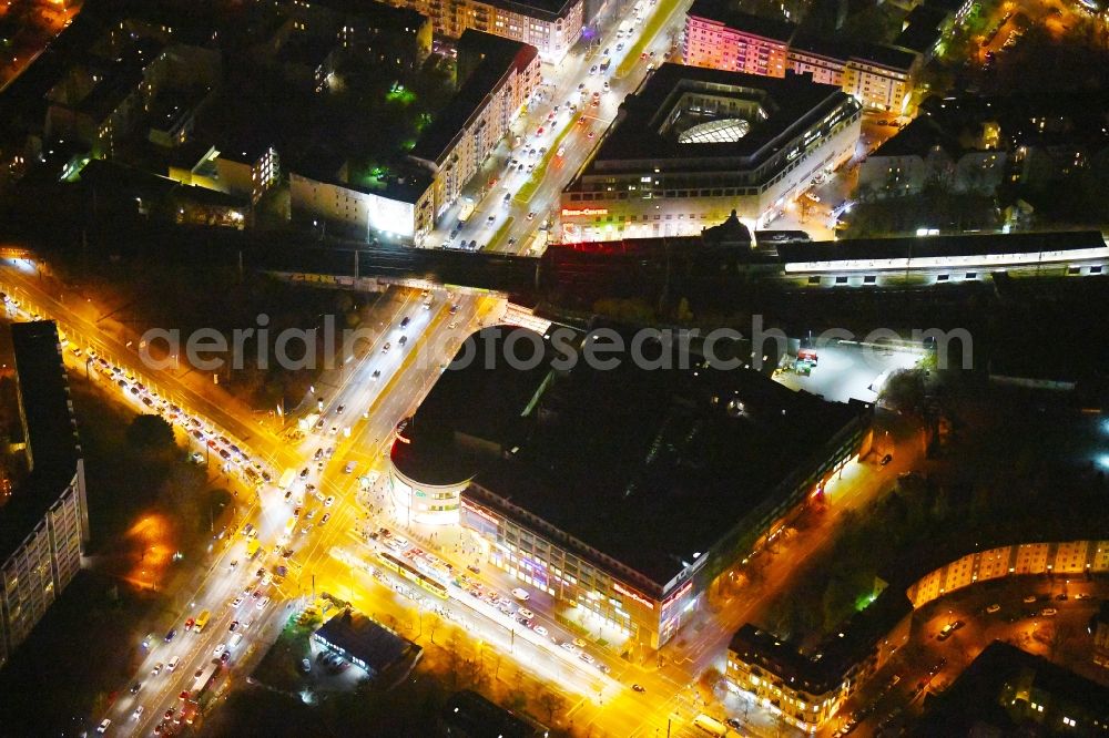 Aerial photograph at night Berlin - Night lighting Building of the shopping center Ring-Center Berlin on Frankfurter Allee in the district Friedrichshain in Berlin, Germany