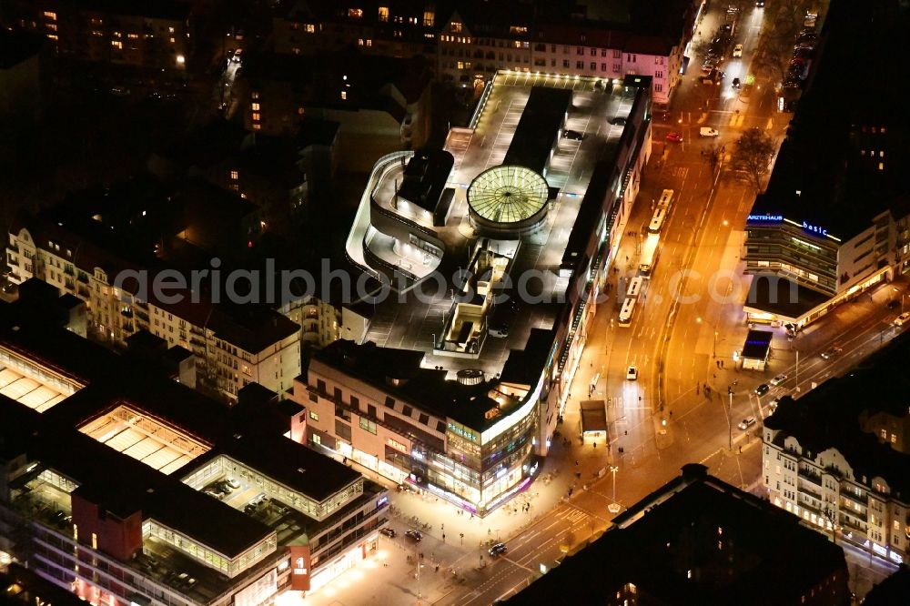 Aerial image at night Berlin - Night lighting building of the shopping center Schloss-Strassen-Center Berlin on place Walther-Schreiber-Platz in the district Friedenau in Berlin, Germany