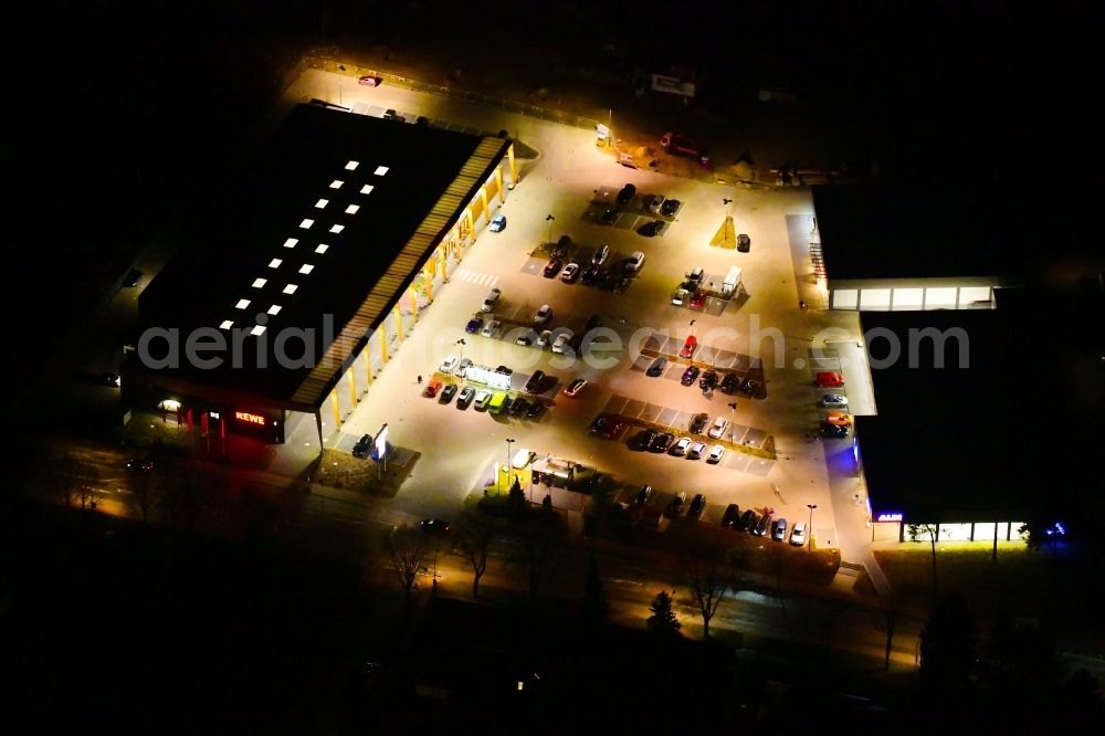 Hohen Neuendorf at night from above - Night lighting building of the shopping center on Schoenfliesser Strasse in Hohen Neuendorf in the state Brandenburg, Germany