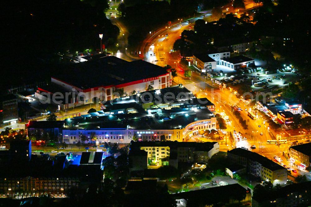 Berlin at night from the bird perspective: Night lighting building of the shopping center Der Clou on stzreet Kurt-Schumacher-Platz - place Kurt-Schumacher-Damm in the district Reinickendorf in Berlin, Germany