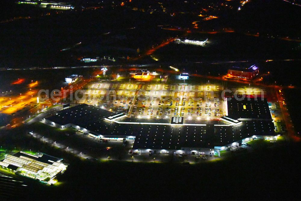 Landsberg at night from above - Night lighting building of the shopping center Halle Center on street Saarbruecker Strasse in the district Peissen in Landsberg in the state Saxony-Anhalt, Germany