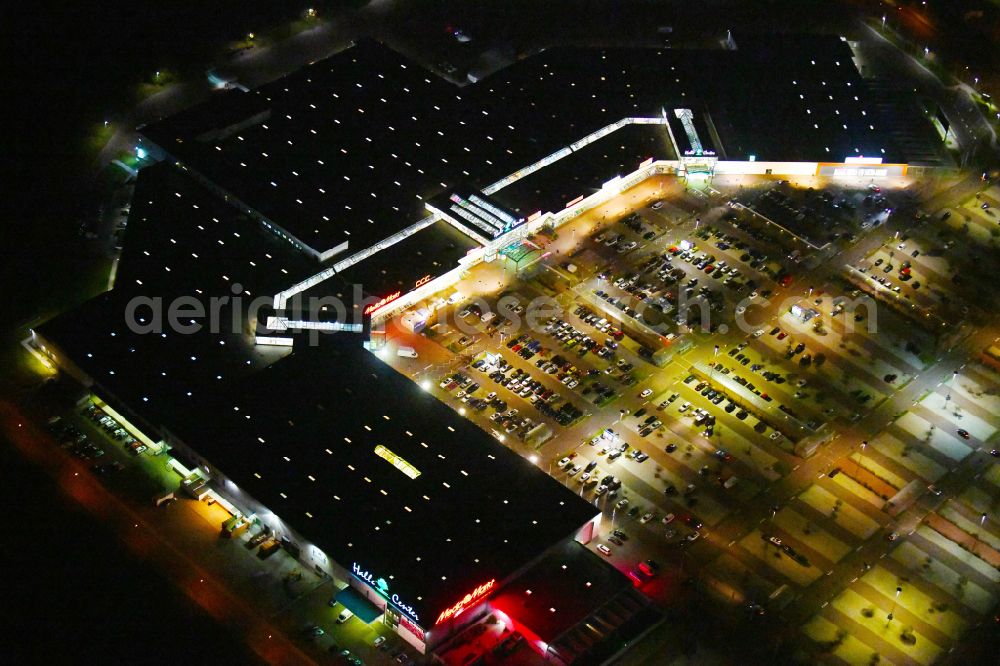 Landsberg at night from above - Night lighting building of the shopping center Halle Center on street Saarbruecker Strasse in the district Peissen in Landsberg in the state Saxony-Anhalt, Germany