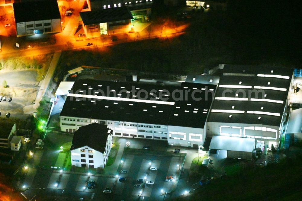 Stedtfeld at night from above - Night lighting buildings and production halls on the vehicle construction site der EDAG Werkzeug + Karosserie GmbH on Weinbergstrasse in Stedtfeld in the state Thuringia, Germany