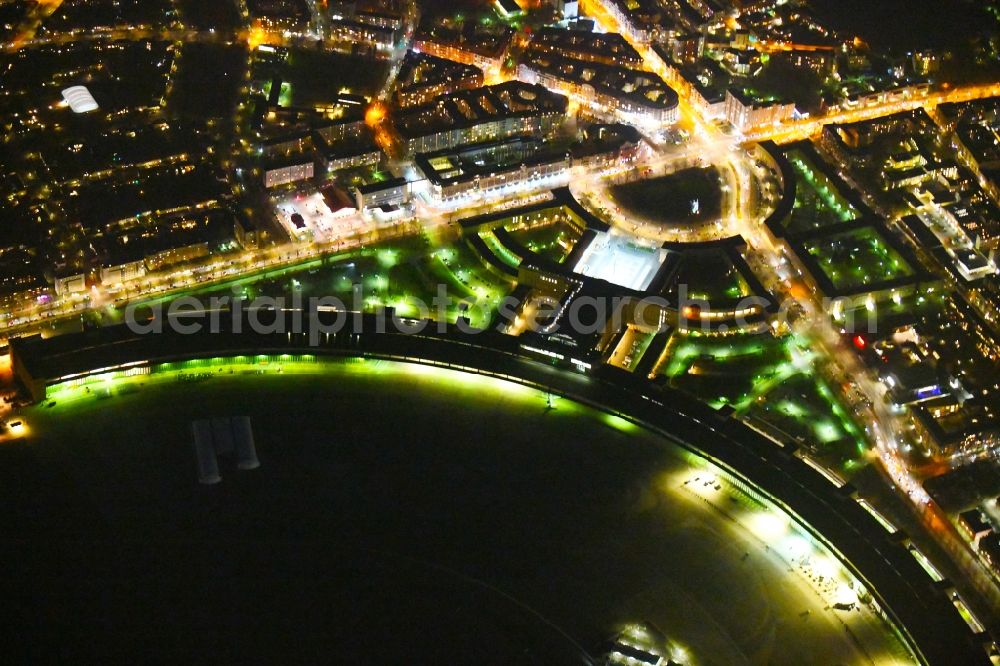 Berlin at night from above - Night lighting Facade of the monument Flughafen Tempelhof on Platz of Luftbruecke in Berlin, Germany