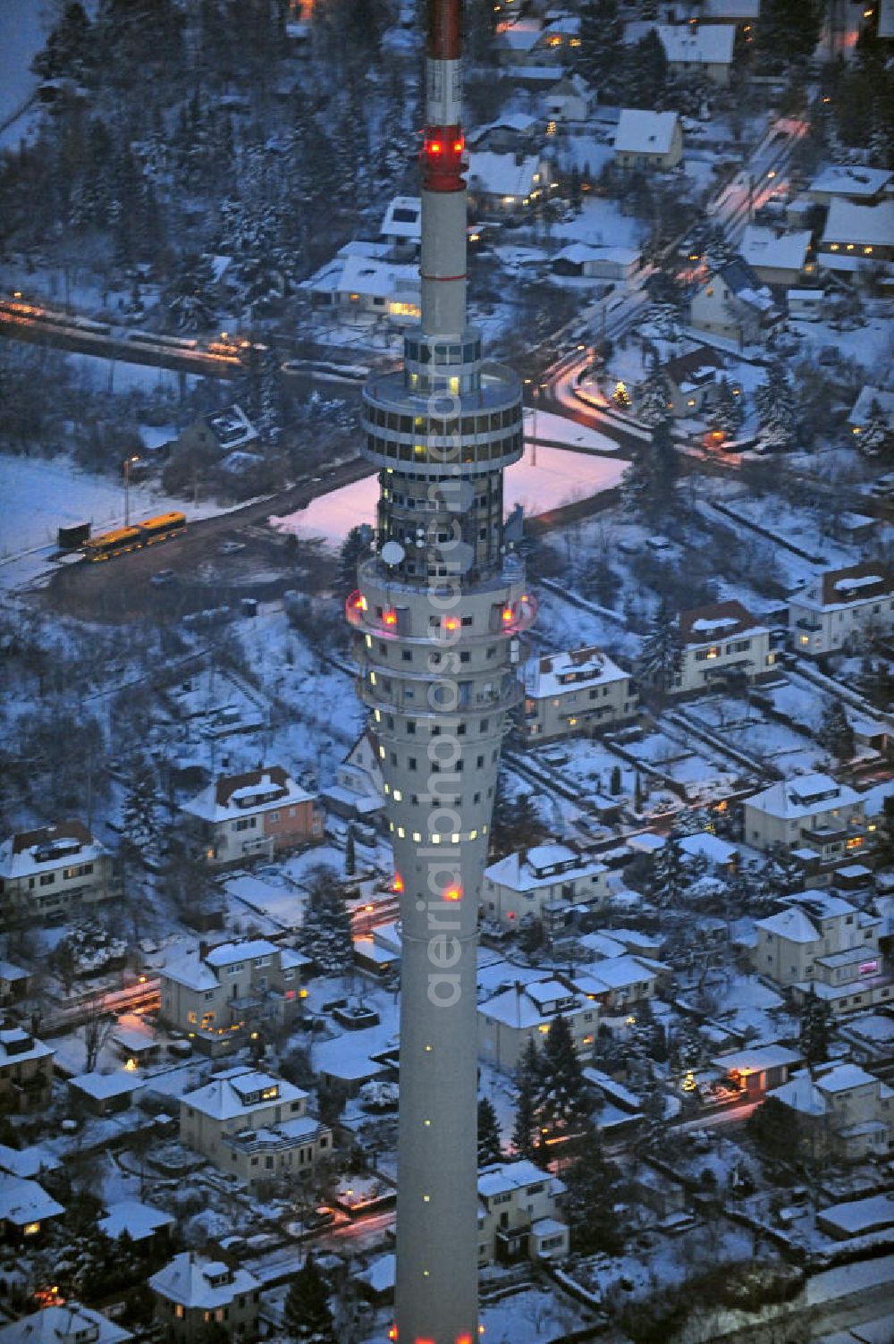 Dresden at night from the bird perspective: Nachtluftbild vom Dresdner Fernsehturm und den winterlich verschneiten Stadtteil Wachwitz mit schneebedeckten Dächern. View of the Dresden TV tower and thewintery area Wachwitz with snow-covered roofs.