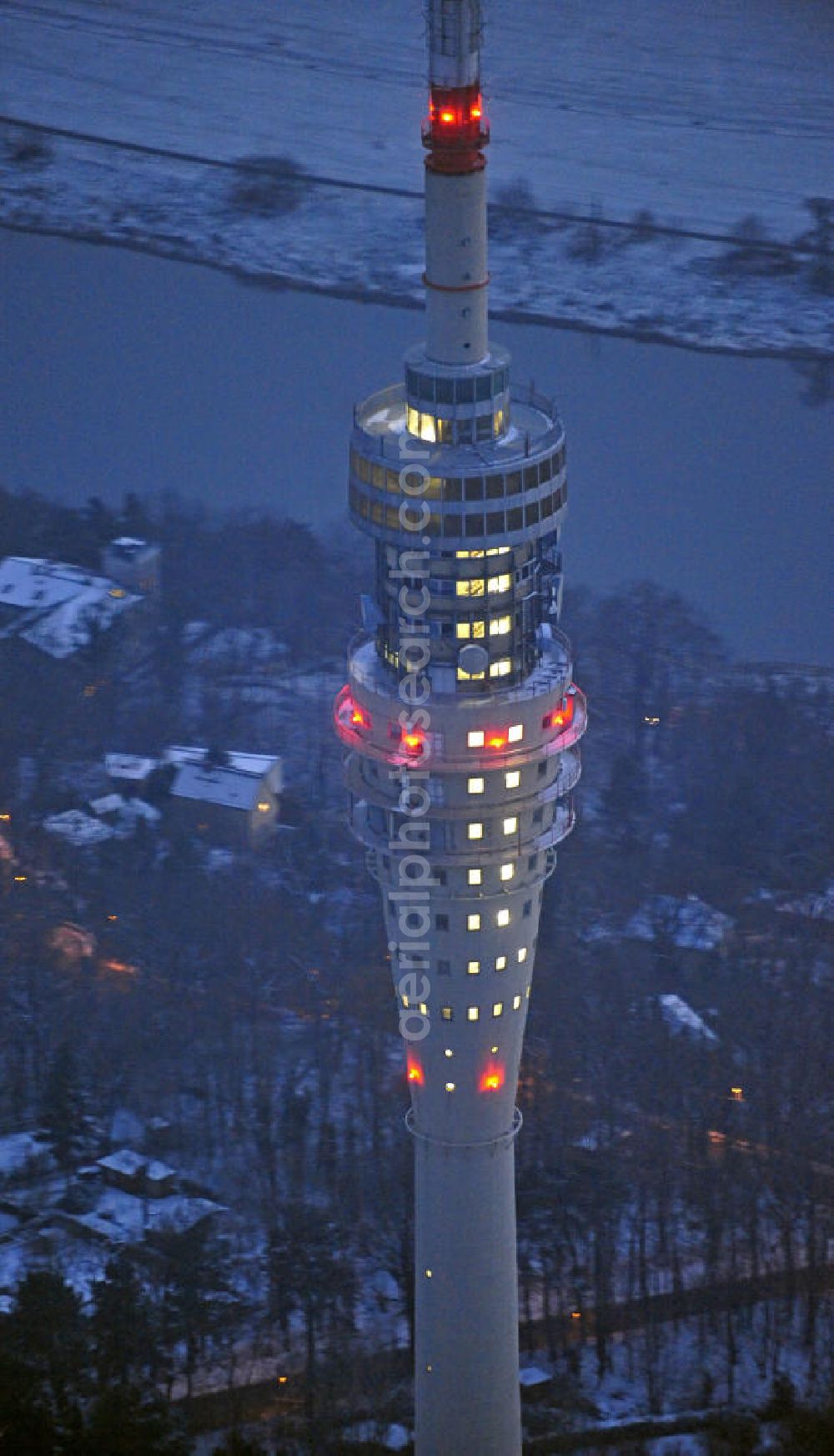 Aerial image at night Dresden - Nachtluftbild vom Dresdner Fernsehturm und den winterlich verschneiten Stadtteil Wachwitz mit schneebedeckten Dächern. View of the Dresden TV tower and thewintery area Wachwitz with snow-covered roofs.