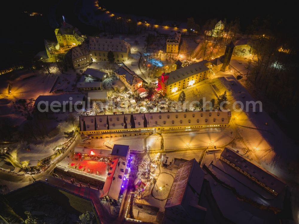 Aerial image at night Königstein - Night lighting the Fortress Koenigstein at the river Elbe in the county district of Saxon Switzerland East Erzgebirge in the state of Saxony. The fortress is one of the largest mountain fortresses in Europe and is located amidst the Elbe sand stone mountains on the flat top mountain of the same name