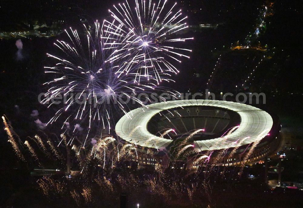 Berlin at night from above - Night lighting Fireworks figures in the night sky above the event grounds of Pyronale Fireworks Competition at the Olympic Stadium in the district Charlottenburg in Berlin, Germany