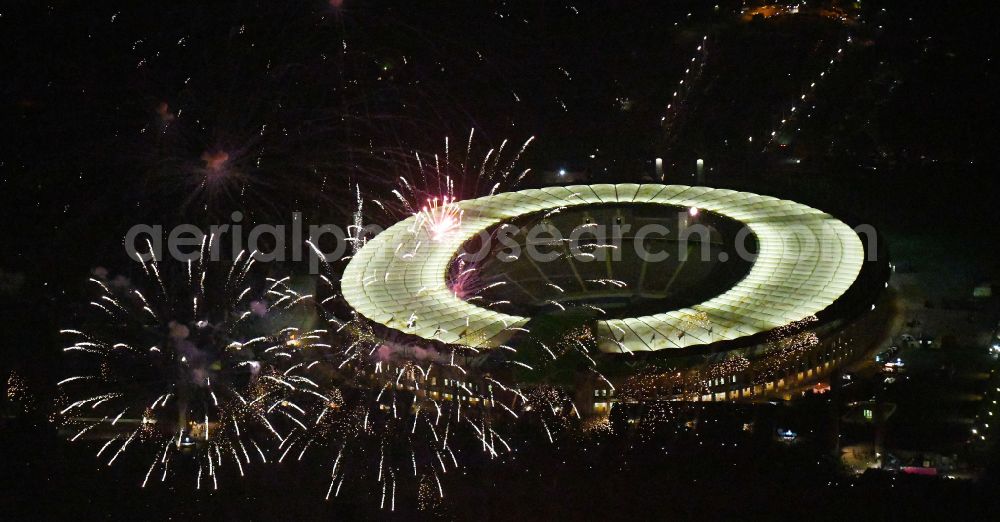 Aerial image at night Berlin - Night lighting Fireworks figures in the night sky above the event grounds of Pyronale Fireworks Competition at the Olympic Stadium in the district Charlottenburg in Berlin, Germany