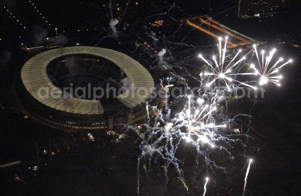 Aerial image at night Berlin - Fireworks figures in the night sky above the event grounds Pyronale on Maifeld in the district Charlottenburg-Wilmersdorf in Berlin, Germany