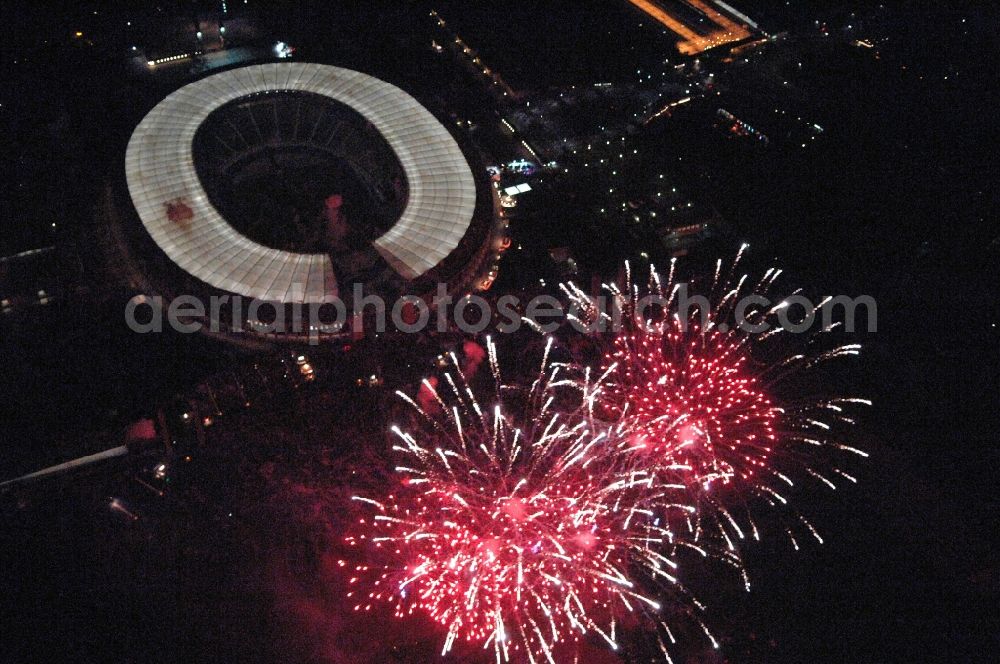 Berlin at night from the bird perspective: Fireworks figures in the night sky above the event grounds Pyronale on Maifeld in the district Charlottenburg-Wilmersdorf in Berlin, Germany