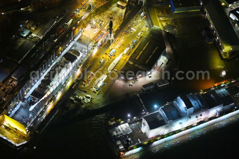 Hamburg at night from the bird perspective: Night lighting ferry ship SPIRIT OF FRANCE on Shipyard on the elbe banks in Hamburg, Germany