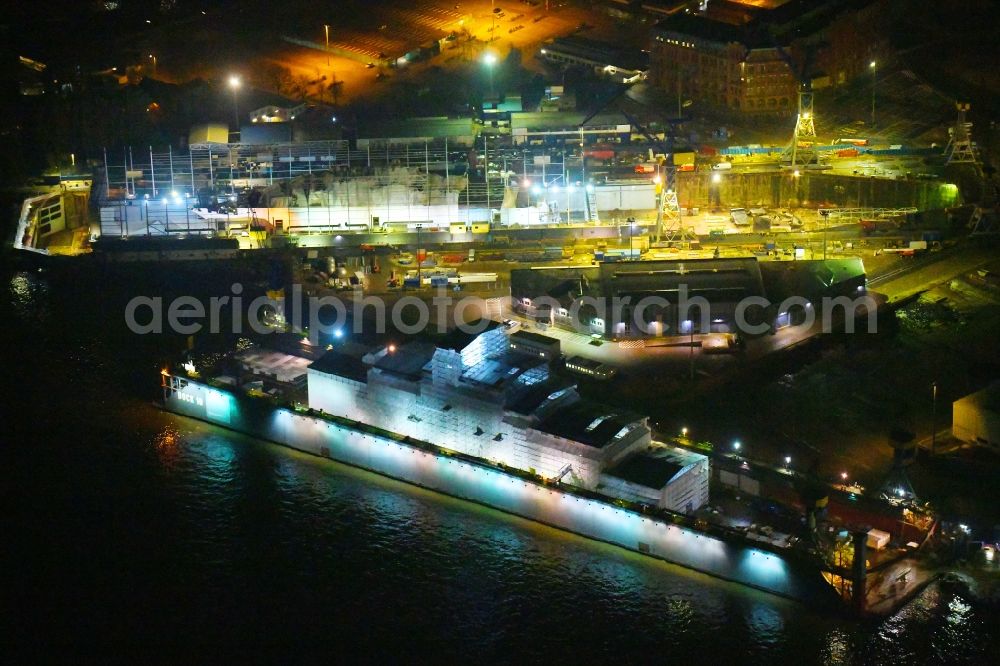 Hamburg at night from the bird perspective: Night lighting ferry ship SPIRIT OF FRANCE on Shipyard on the elbe banks in Hamburg, Germany