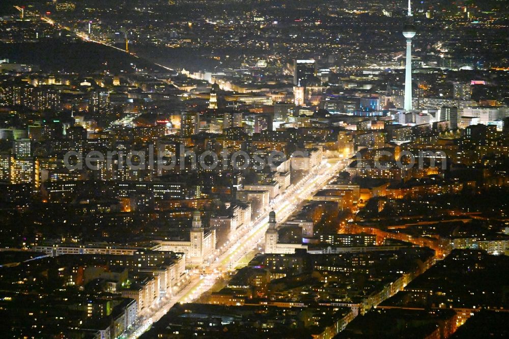 Berlin at night from the bird perspective: Night lighting street guide of famous promenade and shopping street Karl-Marx-Allee with the square at the Frankfurter Tor in the district Friedrichshain in Berlin, Germany