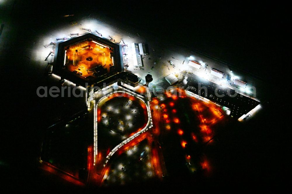 Aerial image at night Berlin - Night lighting refugees Home camp as temporary shelter on the former Flughafen- Gelaende in Berlin, Germany