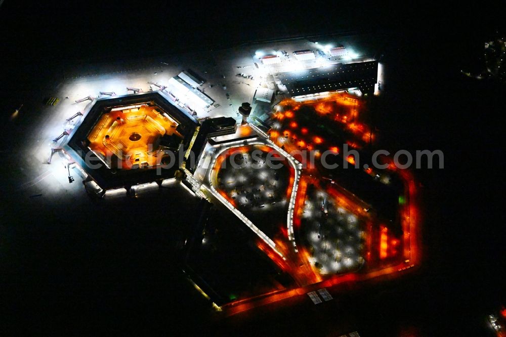 Berlin at night from above - Night lighting refugees Home camp as temporary shelter on the former Flughafen- Gelaende in Berlin, Germany