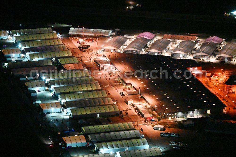 Berlin at night from the bird perspective: Night lighting home and asylum accommodation tent camp as makeshift accommodation Ukraine Arrivals Center TXL in the district of Tegel in Berlin, Germany