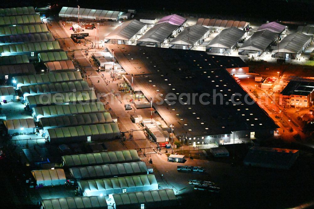 Aerial photograph at night Berlin - Night lighting home and asylum accommodation tent camp as makeshift accommodation Ukraine Arrivals Center TXL in the district of Tegel in Berlin, Germany