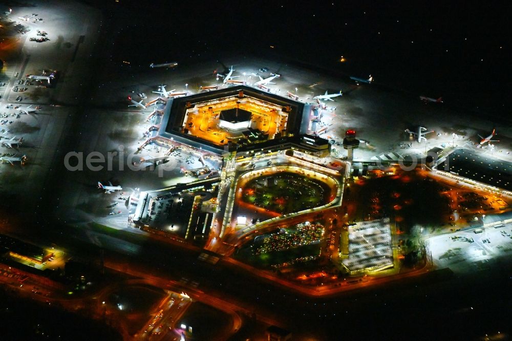 Berlin at night from the bird perspective: Night lighting Flight operations at the terminal of the airport Berlin - Tegel