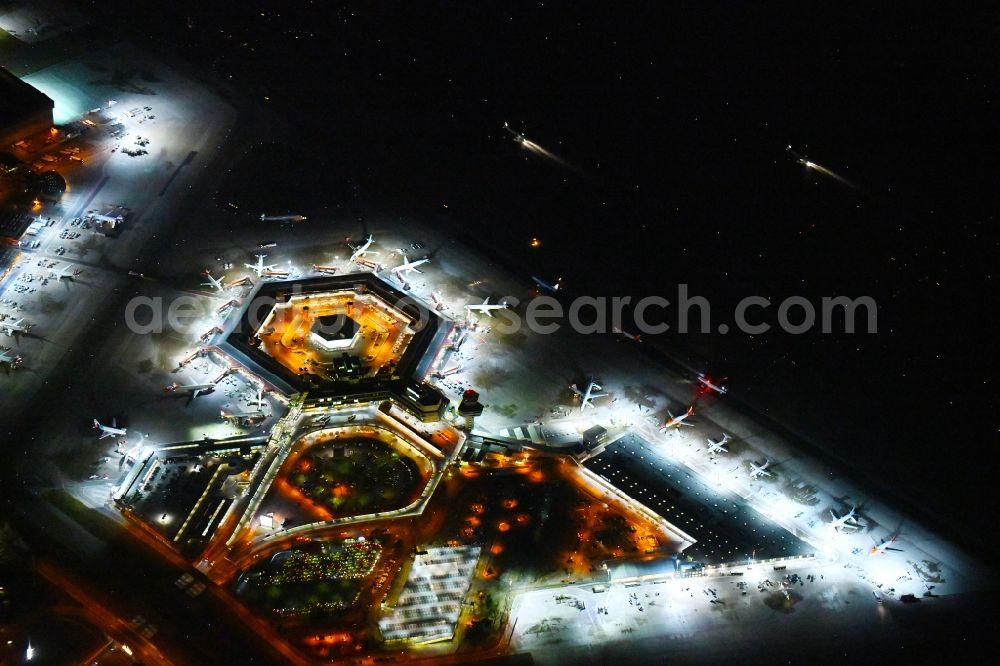 Berlin at night from the bird perspective: Night lighting Flight operations at the terminal of the airport Berlin - Tegel