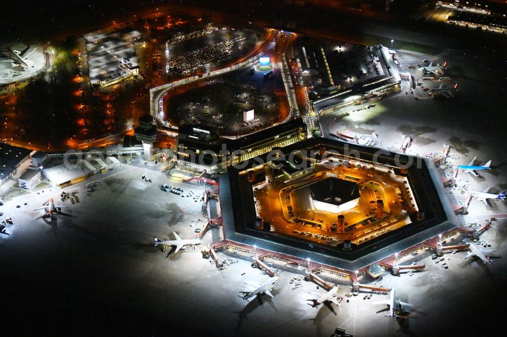 Berlin at night from the bird perspective: Night lighting Flight operations at the terminal of the airport Berlin - Tegel