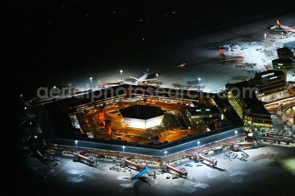 Berlin at night from the bird perspective: Night lighting Flight operations at the terminal of the airport Berlin - Tegel